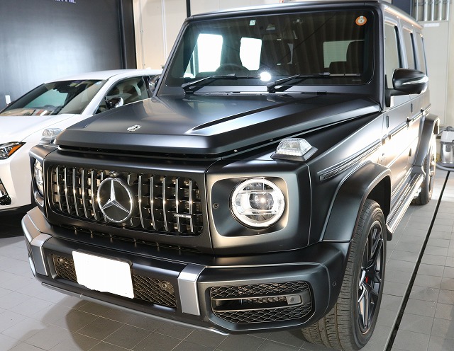 Front view of a black Mercedes‑Benz G-Class SUV in a showroom.